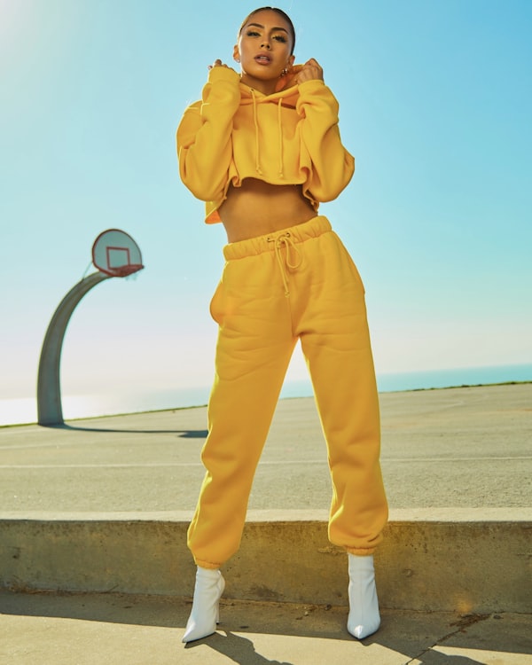 Model in a yellow tracksuit on a seaside basketball court